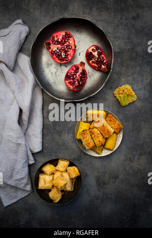 Baklava, Shamiat and pomegranate in bowls, from above Stock Photo