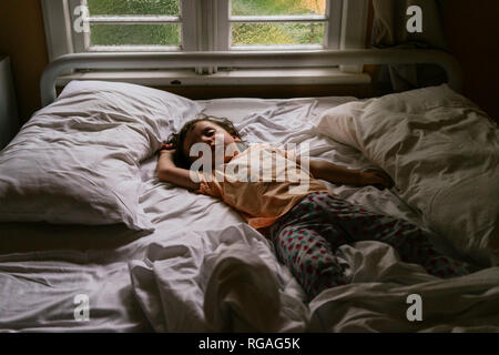 Baby girl sleeping on bed early in the morning Stock Photo