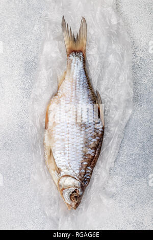 Dried salted fish on grey concrete background.  Traditional Russian appetizer. Selective focus Stock Photo