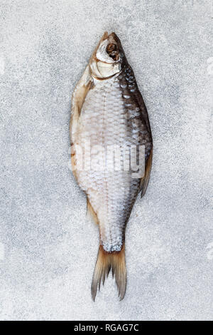 Dried salted fish on grey concrete background.  Traditional Russian appetizer. Selective focus Stock Photo