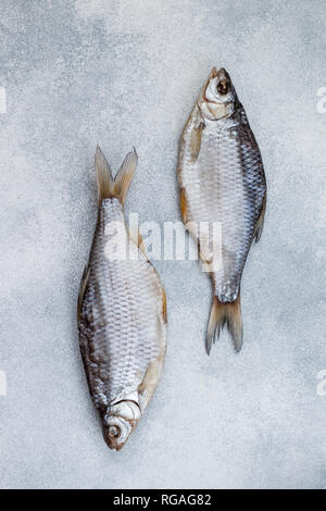 Dried salted fish on grey concrete background.  Traditional Russian appetizer. Selective focus Stock Photo