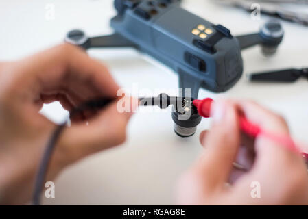 Boy repairing drone Stock Photo