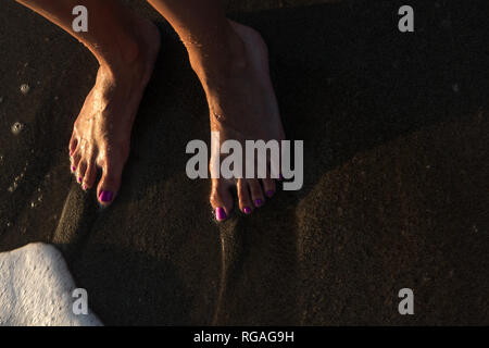 Feet washed by sea waves Stock Photo