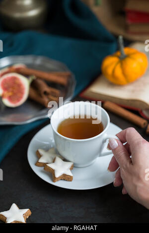 Woman drinking cup of tea in autumn, close-up Stock Photo