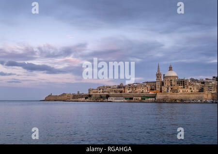 Valletta, capital city of Malta viewed across the harbour, early evening. Stock Photo