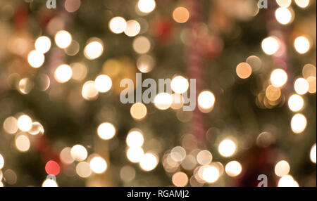 The sparkling lights on a christmas tree with soft focus so everything is blurred. Stock Photo