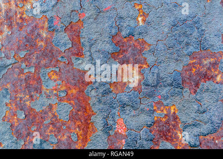 Rusted metal. Rust on a painted metal. Focus at the center of the image. Stock Photo