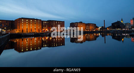 Buildings of the Royal Albert Dock reflect in the Salthouse Dock in Liverpool, England. The dock on the River Mersey is the oldest in Liverpool. Stock Photo