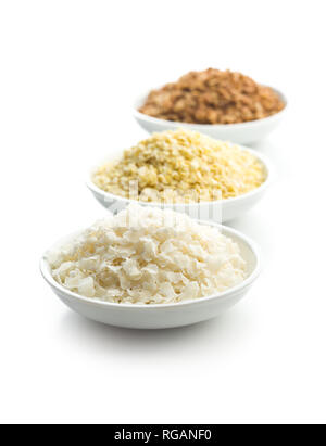 Buckwheat, millet and rice flakes in bowl isolated on white background. Stock Photo