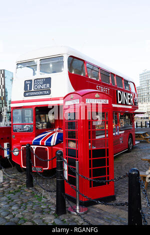 The Street Food Diner at the Royal Albert Dock in Liverpool, England. The double decker bus stands next to British K6 telephone box. Stock Photo