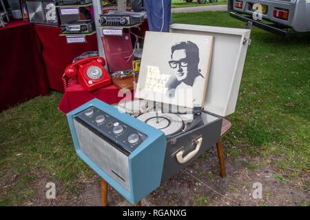 Enfield, Middlesex, UK - May 24, 2015: Old vintage record player standing on a small table.  Lid is open and a record of Buddy Holly Story is propped  Stock Photo
