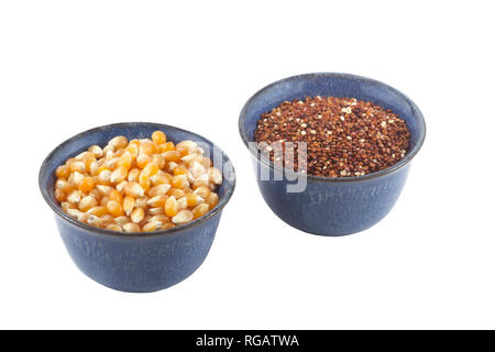 Small bowls of organic popcorn kernels and quinoa. Stock Photo