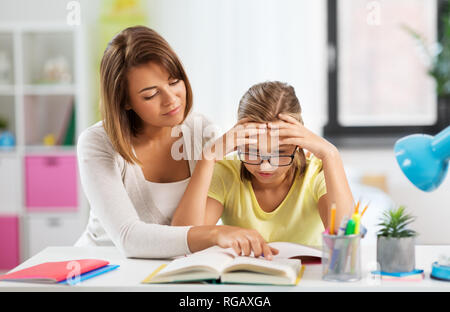 mother helping daughter with difficult homework Stock Photo