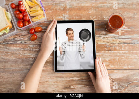 woman watching cooking video on tablet computer Stock Photo