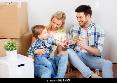 happy family with boxes moving to new home Stock Photo