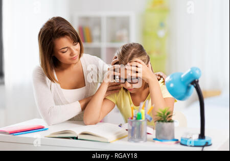 mother helping daughter with difficult homework Stock Photo