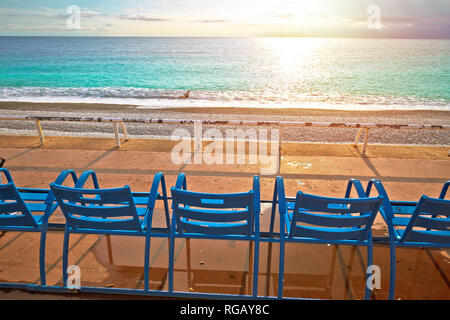 Promenade des Anglais waterfront of Nice benches looking at Mediterranean sunset, famous coastline of French riviera, Alpes Maritimes region of France Stock Photo