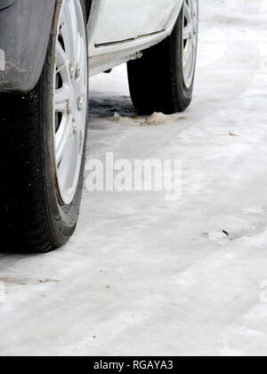 Winter car tires on winter road Stock Photo