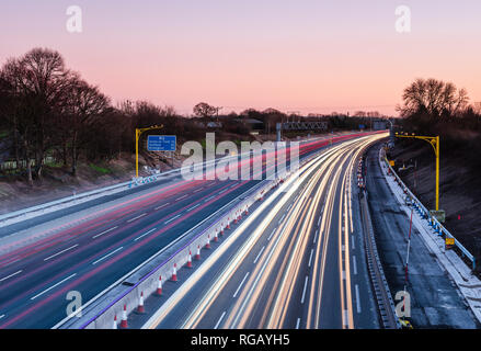 Light trails on the M6 motorway at Sandbach in Cheshire at dusk Stock Photo