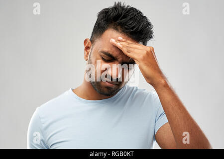 unhappy indian man suffering from headache Stock Photo