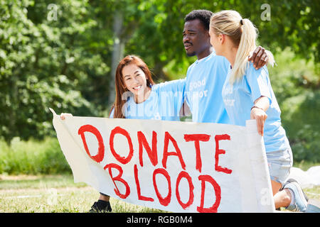 Volunteer volunteers campaign for a blood donation with the text Donate Blood Stock Photo