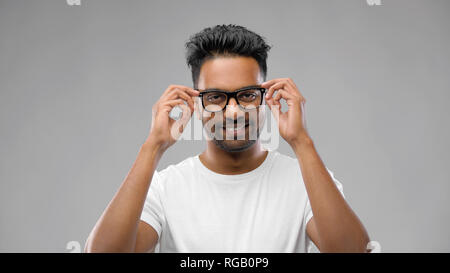 happy indian man in eyeglasses or student Stock Photo