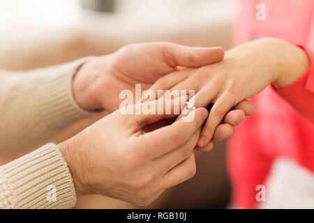 man giving diamond ring to woman on valentines day Stock Photo