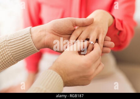 man giving diamond ring to woman on valentines day Stock Photo