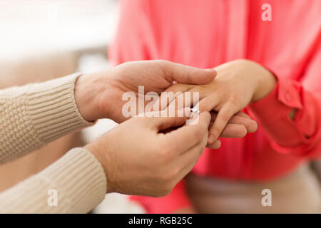 man giving diamond ring to woman on valentines day Stock Photo