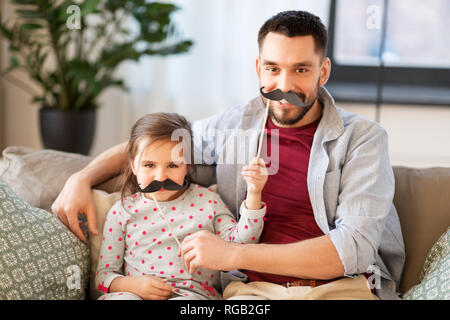 father and daughter with mustaches having fun Stock Photo