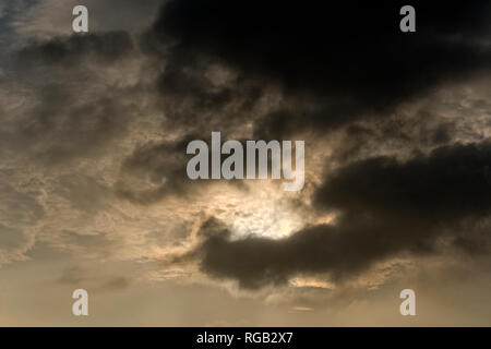 Dark clouds covering the sun Stock Photo