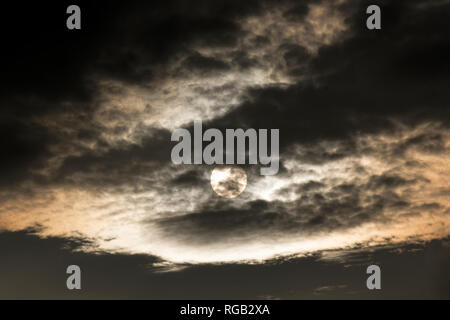 Dark clouds covering the sun Stock Photo