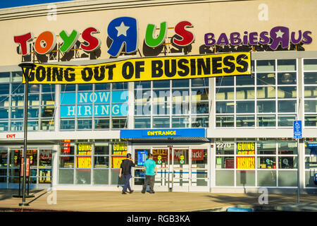 April 20, 2018 San Mateo / CA / USA - Toys R Us logo and 'Going out of business' announcement above the entrance to one of the locations in San Franci Stock Photo