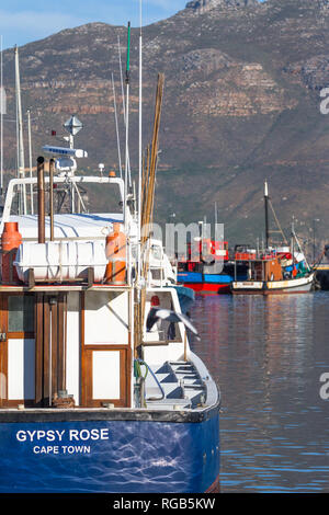 Hout Bay harbour and fishing boats moored to the jetty Stock Photo