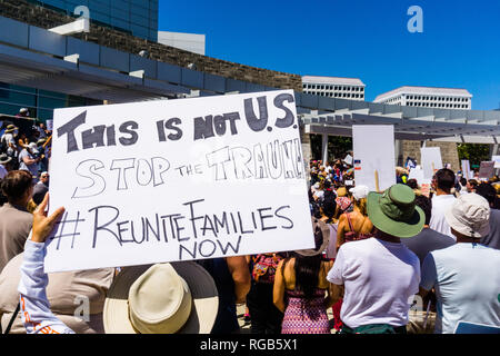 June 30, 2018 San Jose / CA / USA - "This is not U.S., Stop the trauma, #reunitefamiliesnow " sign raised at the "Families belong together" rally held Stock Photo
