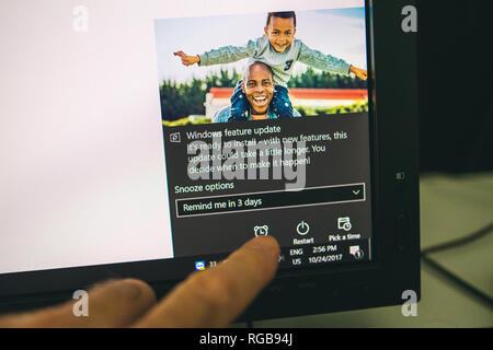 LONDON, UNITED KINGDOM - oct 24, 2017: Setting Up button to remind the installation of the MIcrosoft Windows feature update Stock Photo