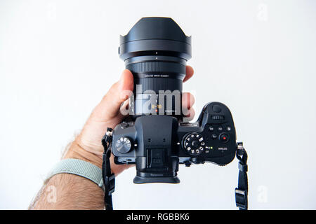 PARIS, FRANCE - JUN 30, 2018: Man showing new Panasonic Lumix DMC-GH5 - and newest Leica Vario-Elmarit 8-18 Micro Four Thirds System digital still and video camera with 4K 10 bit Video recording internal capability Stock Photo