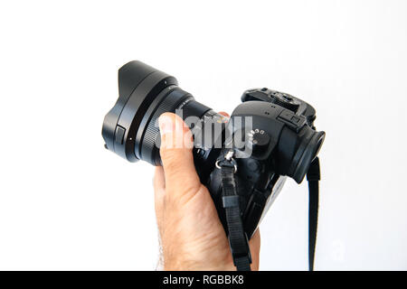PARIS, FRANCE - JUN 30, 2018: Man showing new Panasonic Lumix DMC-GH5 - and newest Leica Vario-Elmarit 8-18 Micro Four Thirds System digital still and video camera with 4K 10 bit Video recording internal capability Stock Photo