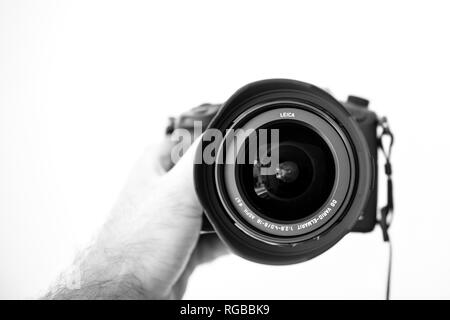 PARIS, FRANCE - JUN 30, 2018: Man showing New Panasonic Lumix DMC-GH5 - and newest Leica Vario-Elmarit 8-18 Micro Four Thirds System digital still and video camera with 4K 10 bit Video recording internal capability Stock Photo