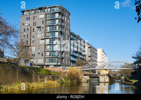 New apartment building and bridge over the Regents Canal, between Limehouse and Mile End, East London UK Stock Photo