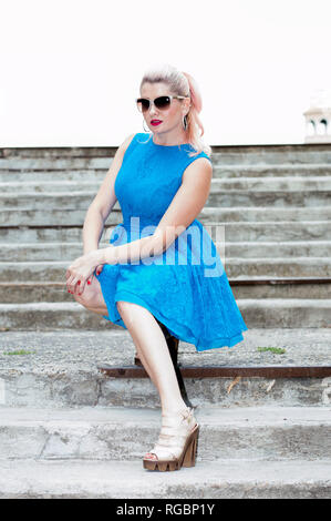 beautiful woman sat down on the steps, theme beautiful bright women Stock Photo