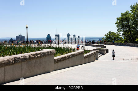 Montreal, Quebec, Canada, June 3, 2018: Sunny day at the Kondiaronk Belvedere, and people looking at the city from the top of the Mount Royal Stock Photo