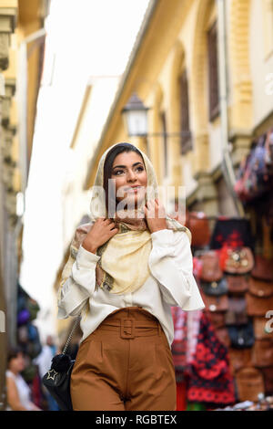 Spain, Granada, young muslim tourist woman wearing hijab during sightseeing in the city Stock Photo
