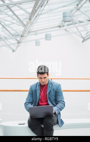 Businessman in lobby of a modern building, using Stock Photo