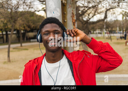 Young black man with headphones, smiling, portrait Stock Photo