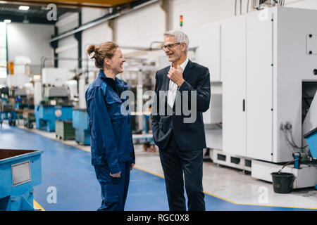 Manager and skilled worker of a high tech enterprise having a meeting Stock Photo
