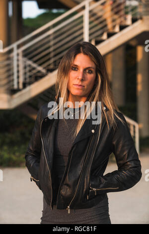 Portrait of young woman wearing a leather jacket Stock Photo