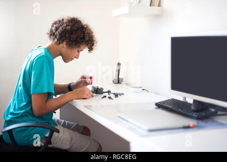 Boy repairing drone Stock Photo
