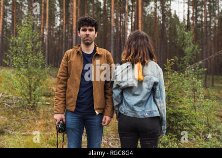 Finland, Lapland, man with camera and woman standing in rural landscape Stock Photo