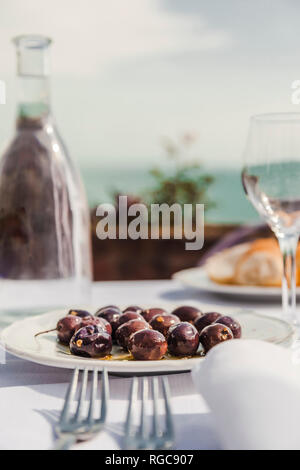 Italy, Atrani, black olives on plate Stock Photo